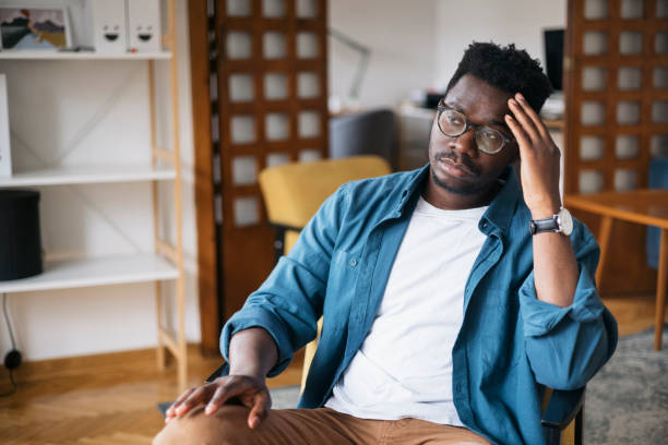 istock Young man feeling depressed at home 1401933328