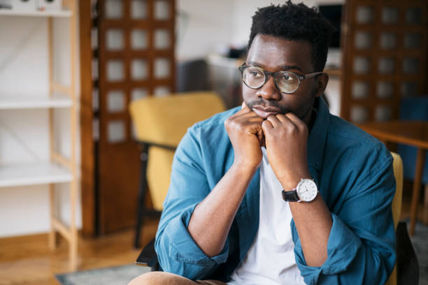 istock Young man feeling depressed at home 1401934368