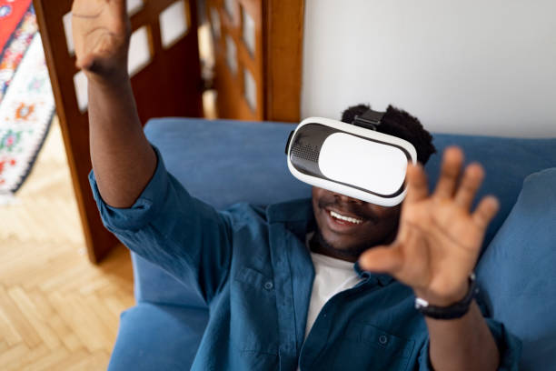 istock Male gamer using virtual reality googles at home 1401934371