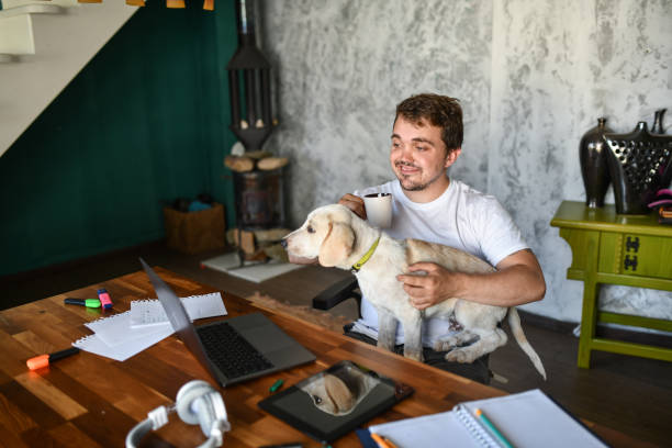 istock Dwarf Male Waiting For New Project From Client While Petting Dog, Drinking Coffee And Working From Home 1401934758