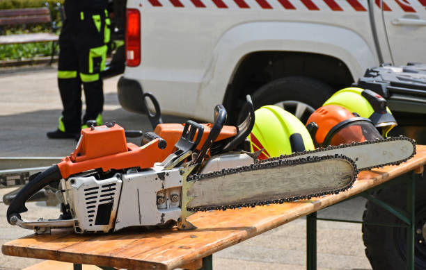 Chainsaws and helmets on a table outdoor