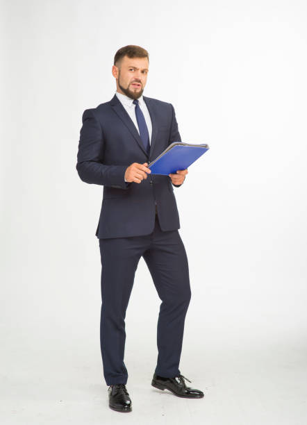 istock young businessman in a suit and with a blue folder without inscriptions posing with different emotions on a white background in the studio isolated in full growth 1401935357