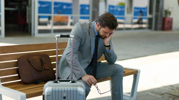 istock Pensive businessman is waiting at train station alone 1401936308