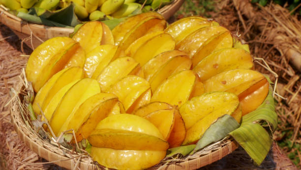 Close-up star fruit or star apple, These are a group of yellow in a wicker basket. Close-up star fruit or star apple, These are a group of yellow in the wicker basket. starfruit stock pictures, royalty-free photos & images