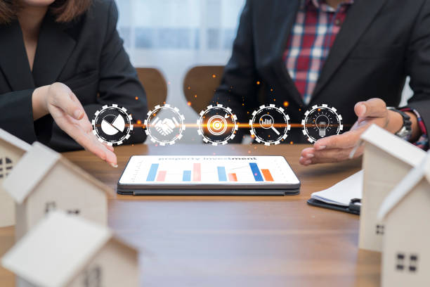 Real estate concept, property value diagram, businessman using tablet with investment icon. Real estate concept, property value diagram, businessman using a tablet with investment icons on his desk. types of loans stock pictures, royalty-free photos & images