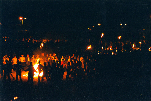 The night of torch Festival, People danced around the bonfire.Film photo in 08/16/1998,Chuxiong city,Yi Autonomous Prefecture of Chuxiong,Yunnan.