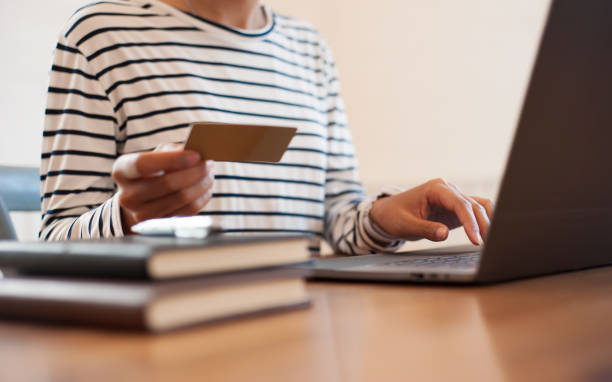 istock Woman holding credit card while using top. Online shopping concept. 1401937226