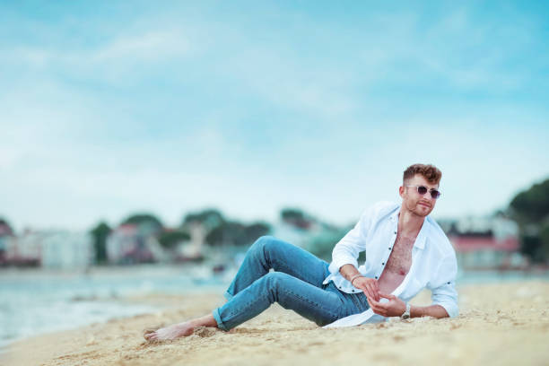 istock young handsome man on the beach in summer season 1401939775