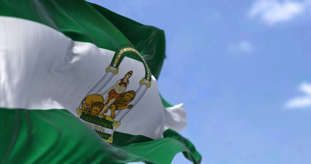Andalusian flag waving in the wind on a clear day Andalusian flag waving in the wind on a clear day. Andalusia is the southernmost autonomous community in Peninsular Spain, the most populous and the second largest autonomous community in the country andalusia stock pictures, royalty-free photos & images
