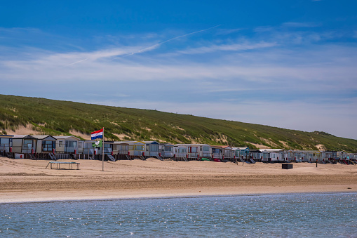 View of beach huts on the beach in Egmnd aan Zee/Netherlands in front of a large dune