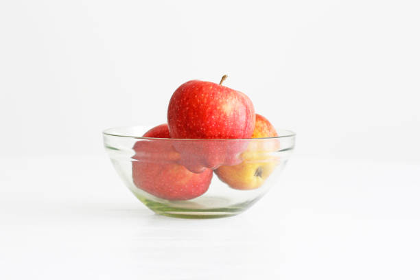 istock Apples in a glass bowl on white background 1401941735