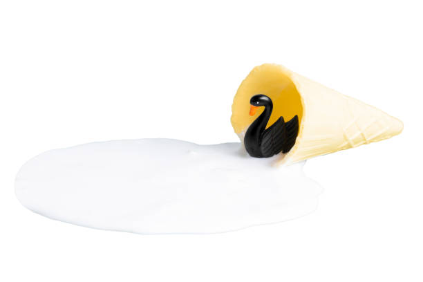 istock Black swan figurine in ice cream puddle on white 1401942426