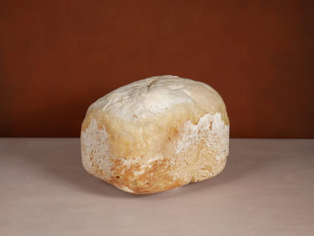 istock Homebread. Loaf of bread on brown background 1401942475