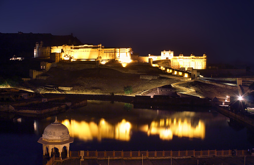 illuminated fort and lake in Jaipur India at night