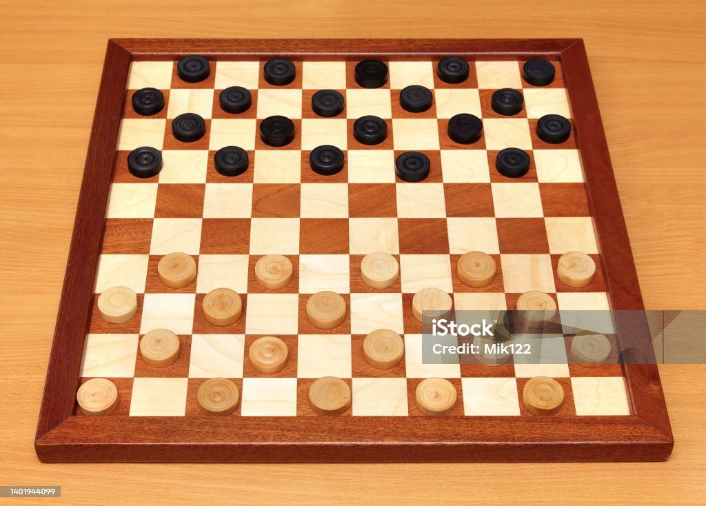 checkerboard with checkers spaced wooden checkerboard with checkers spaced on table Black Color Stock Photo