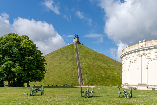 Waterloo, Belgium - 6 June, 2022: view of the Lion's Mound and cannons at the Waterloo Battlefield Memorial outisde of Brussels