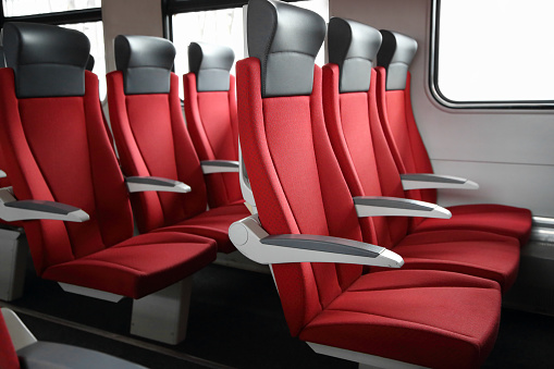 rows of red seats in modern train