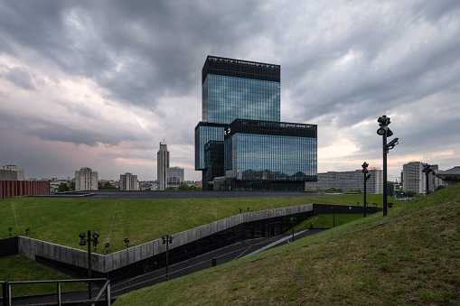 Katowice, Poland - May 8, 2022: view from Spodek building on modern KTW building complex under dramatic sky at sunset hour