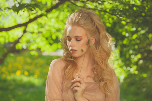 Beautiful woman walking in summer park
