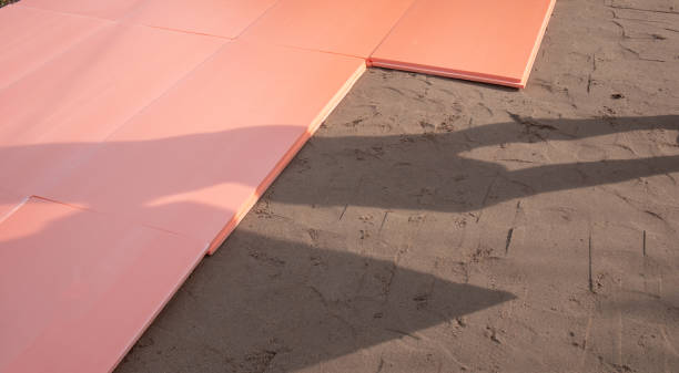 The polyplex polystyrene slab is laid on wet sand as insulation for the foundation of an outdoor swimming pool stock photo
