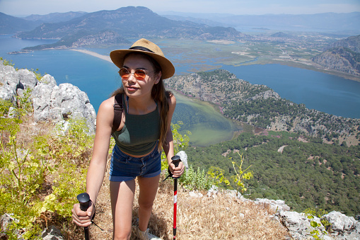 young woman trekking at the peak of dalyan Turkey