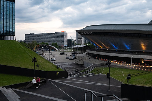 Katowice, Poland - May 8, 2022: view on illuminated  Spodek building under dramatic sky at sunset hour