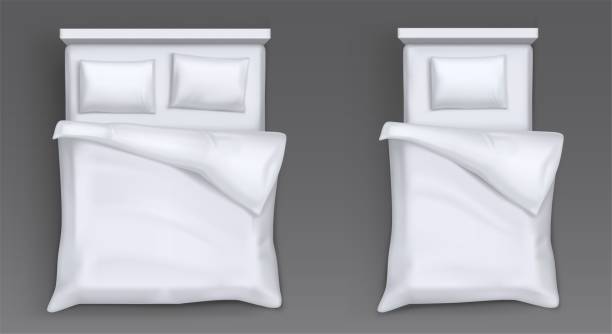 Beds with white pillows, blanket, sheet Top view of beds with mattress, white pillows, blanket and sheet. Vector realistic mockup of 3d hotel or house furniture for sleep and rest with blank linen bedclothes sheet bedding stock illustrations