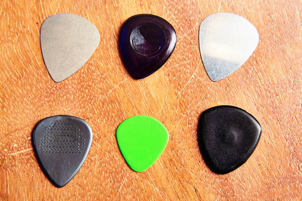 istock Group of guitar picks on a wooden surface 1401950862