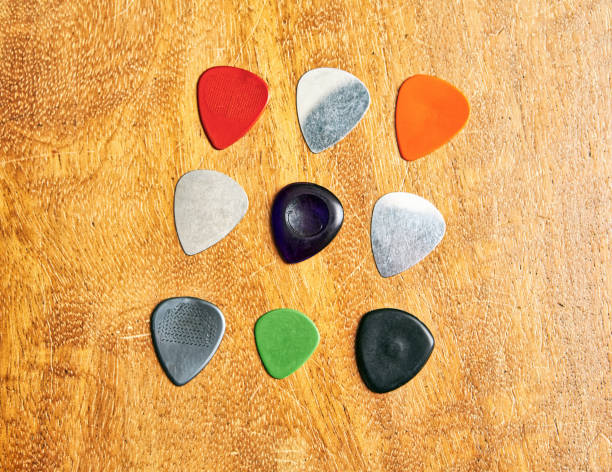 istock Group of guitar picks on a wooden surface 1401950896