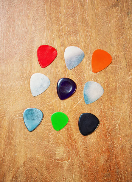 Group of guitar picks on a wooden surface
