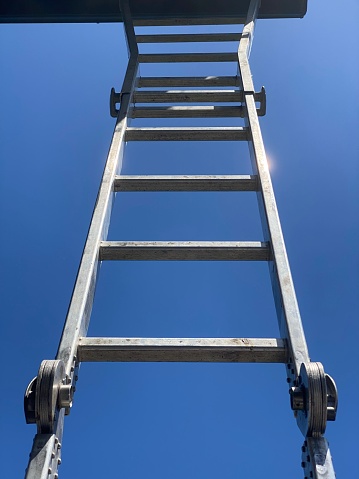 Underneath ladder with a blue sky above