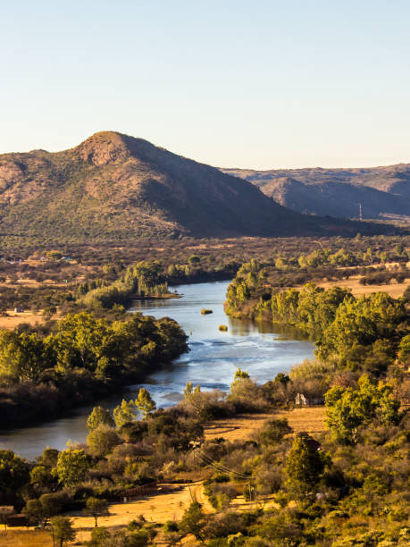 View over the Vaal River where it flows through the undulating hills of the Vredefort Dome, in South Africa These high concentric ridges, which dominates the landscape formed about 2020 million years ago by an Asteroid impact. This is the largest known asteroid impact on earth bushveld photos stock pictures, royalty-free photos & images