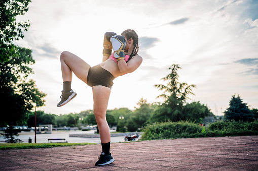 Young woman practicing boxing outdoor