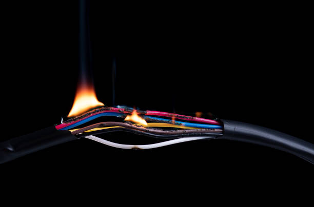 istock Electric cable wire broken or torn, power energy circuit, burning fire flame, connection break on black background 1401953113