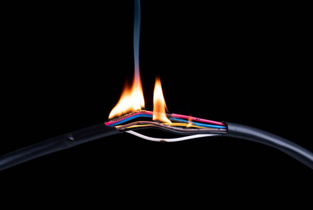 istock Electric cable wire broken or torn, power energy circuit, burning fire flame, connection break on black background 1401953114