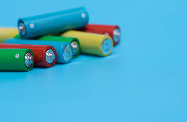 istock Colorful batteries alkaline 1.5 Volts in size AA on blue background 1401953225