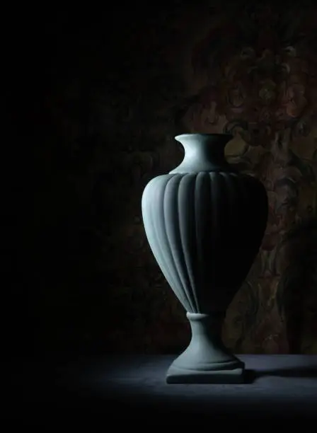 Retro, vintage urn, chiaroscuro in antique setting. Green ceramic.
