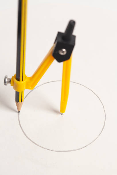 Yellow compass with pencil isolated on white background.