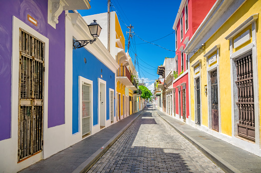 Cobbled alley and colorful houses in Old San Juan (Viejo San Juan), Puerto Rico on a sunny day.