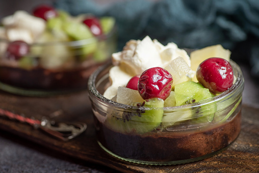 Fruit cake with kiwi and cherries in a glass .Top view. Stock photo.