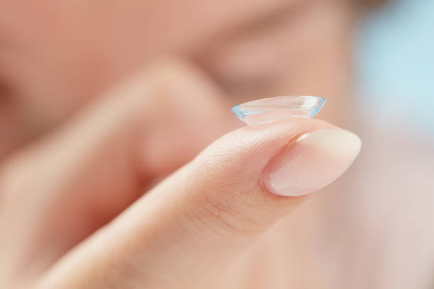 istock Contact lens on female finger. 1401964261