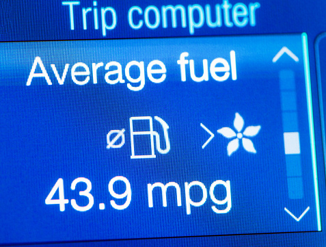 Close-up of a car's trip computer screen, showing a calculation of average fuel economy, in miles per gallon.