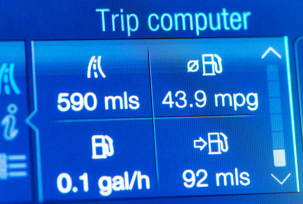 Close up showing automatically calculated figures showing driving distance and fuel economy stats on a car's dashboard screen.