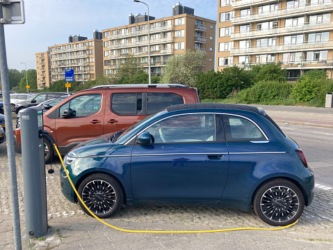 Kijkduin, the Netherlands - May 7 2022: Electric car Fiat 500 at plug in charge station in the Netherlands
