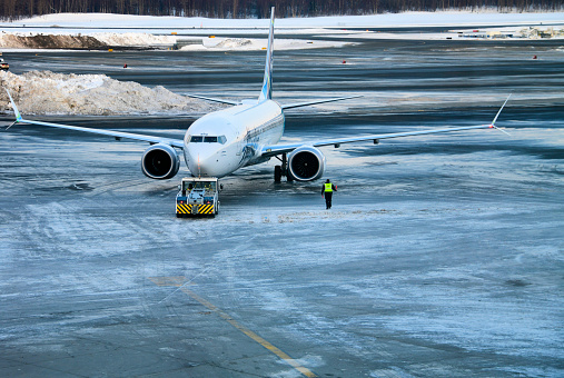 Anchorage, Alaska, USA: Alaska Airlines Boeing 737-9 MAX, N920AK, MSN 44086 - with tractor for pushback - frozen apron at Ted Stevens Anchorage International Airport.