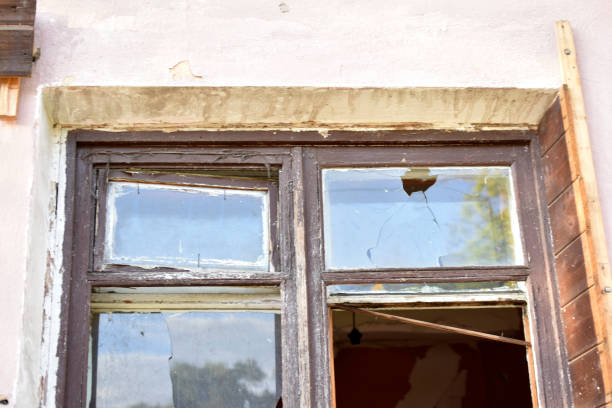 istock The window in the house is broken glass hooliganism. 1401971504