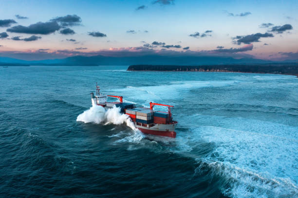 istock Stormy sea with Container ship delivering cargo at sunset 1401972324