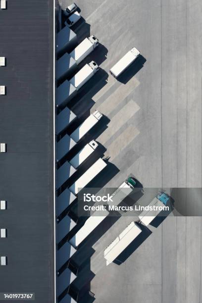 Trucks At The Loading Bay Of A Warehouse Stock Photo - Download Image Now - Truck, Warehouse, Transportation