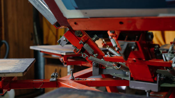 istock silkscreen printing on t-shirts in a design studio. serigraphy production. print screening apparatus selective focus photo 1401975059