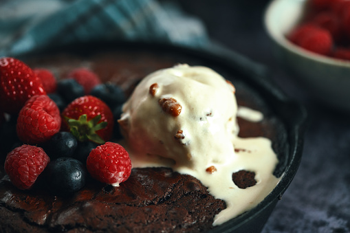 Chocolate Brownie Baked in a Pan and Served with Berries and Ice Cream